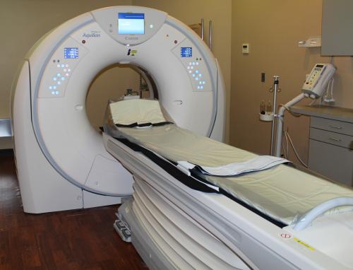 nurse helping patient in an MRI machine